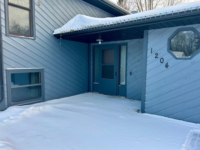 view of snow covered property entrance