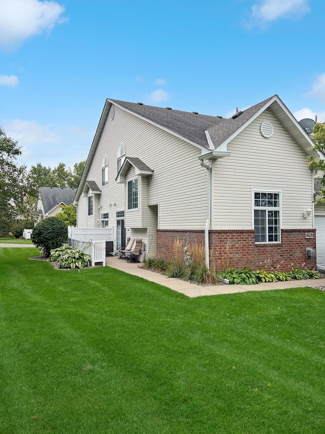 back of property featuring a lawn