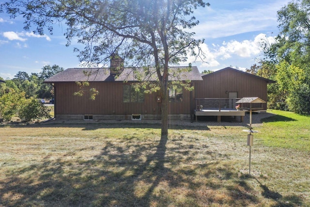 view of side of home with a yard and a wooden deck