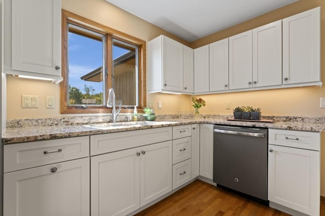 kitchen featuring wood-type flooring, sink, light stone countertops, stainless steel dishwasher, and white cabinetry