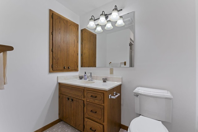 bathroom featuring vanity, toilet, and tile patterned flooring