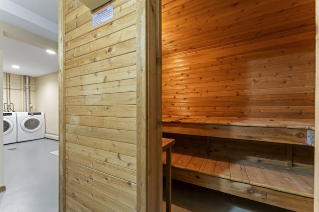 view of sauna / steam room featuring concrete flooring and wood walls