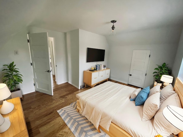 bedroom featuring vaulted ceiling and dark hardwood / wood-style flooring