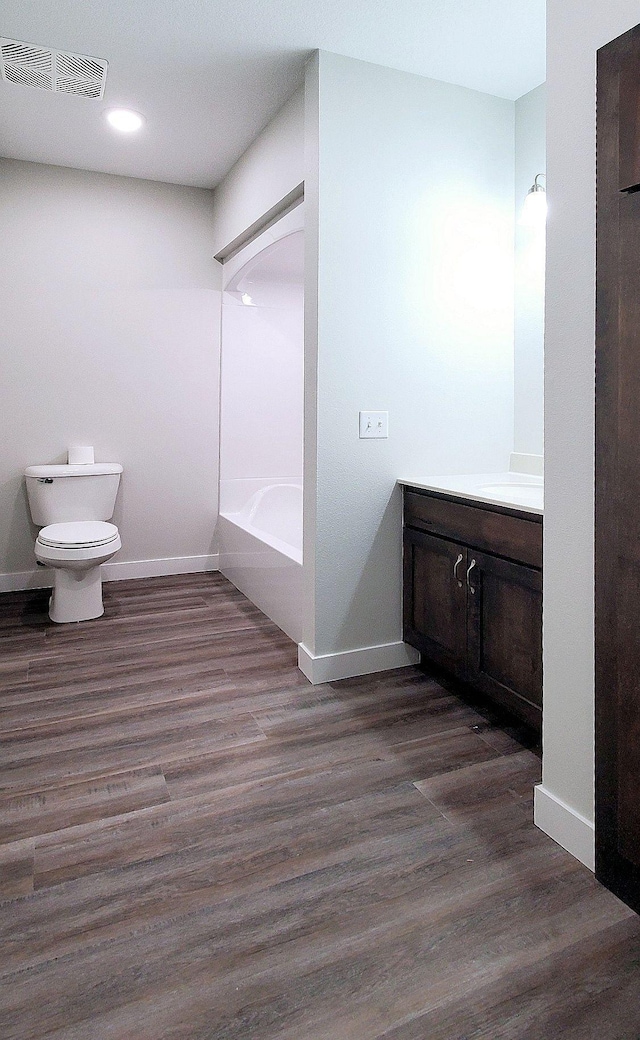 bathroom featuring vanity, hardwood / wood-style floors, and toilet