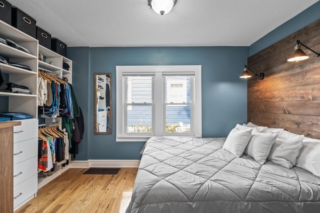 3509 43rd Ave S, Minneapolis, MN 55406 - bedroom with a textured ceiling, light wood-style flooring, and a closet