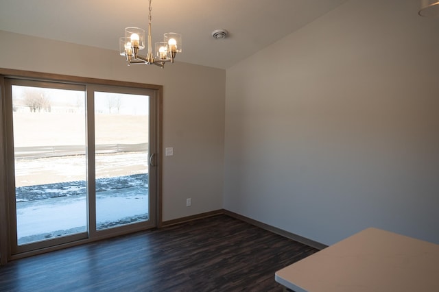 unfurnished room featuring lofted ceiling, a notable chandelier, and dark hardwood / wood-style floors