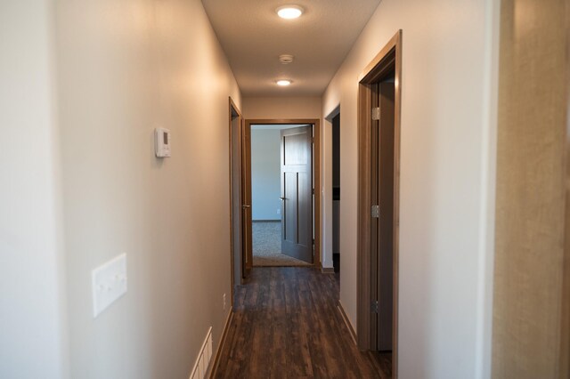 corridor with dark wood-type flooring