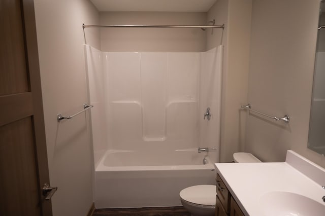 full bathroom featuring vanity, hardwood / wood-style floors, tub / shower combination, and toilet