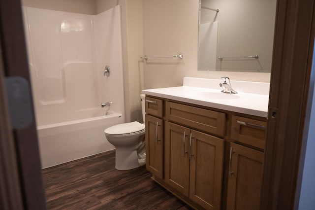 full bathroom with wood-type flooring, shower / washtub combination, vanity, and toilet