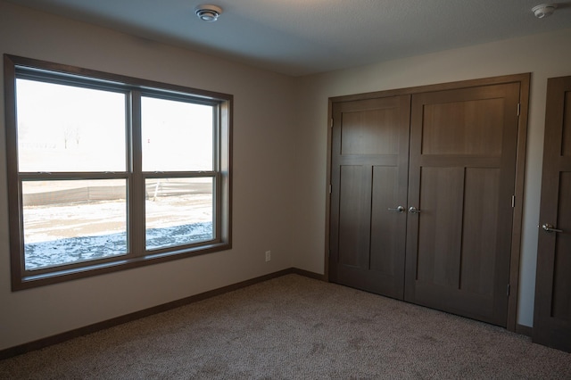 unfurnished bedroom featuring a closet and carpet flooring