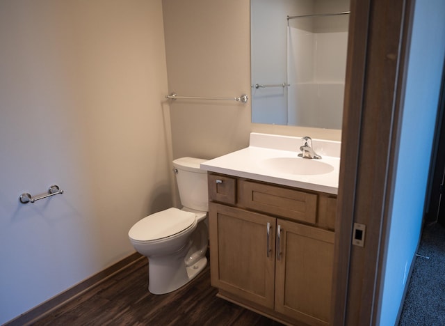 bathroom featuring hardwood / wood-style flooring, vanity, and toilet