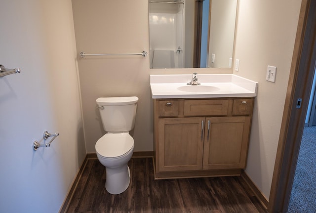 bathroom with hardwood / wood-style flooring, vanity, and toilet