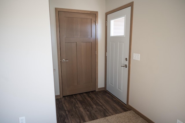 2218 Red Bird Ln, Fairmont, MN 56031 - doorway to outside featuring baseboards and dark wood-type flooring