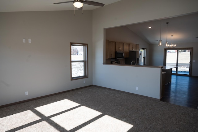 2218 Red Bird Ln, Fairmont, MN 56031 - kitchen featuring stainless steel appliances, dark colored carpet, lofted ceiling, a ceiling fan, and open floor plan
