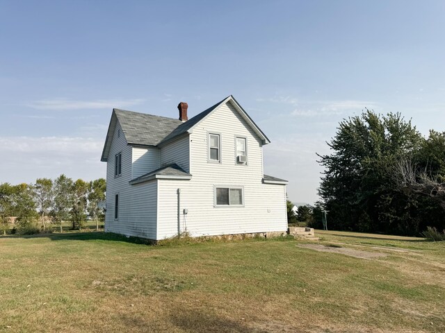 rear view of house with a lawn