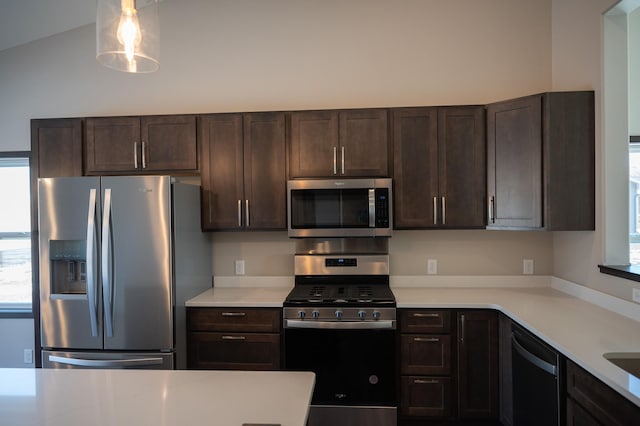 kitchen with stainless steel appliances, plenty of natural light, pendant lighting, and dark brown cabinetry