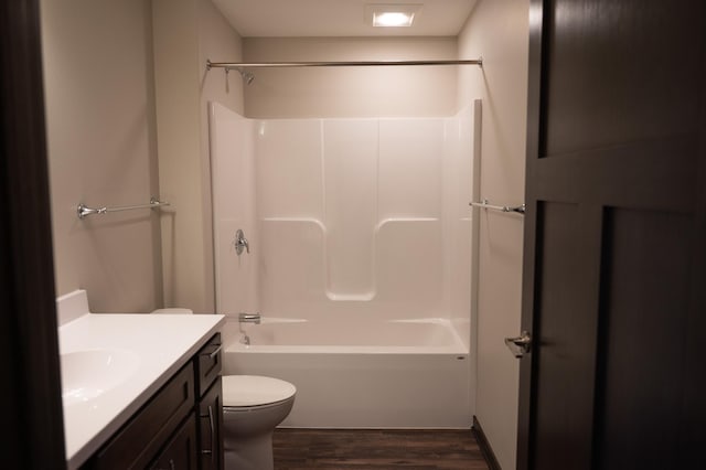 full bathroom featuring vanity, hardwood / wood-style floors, tub / shower combination, and toilet