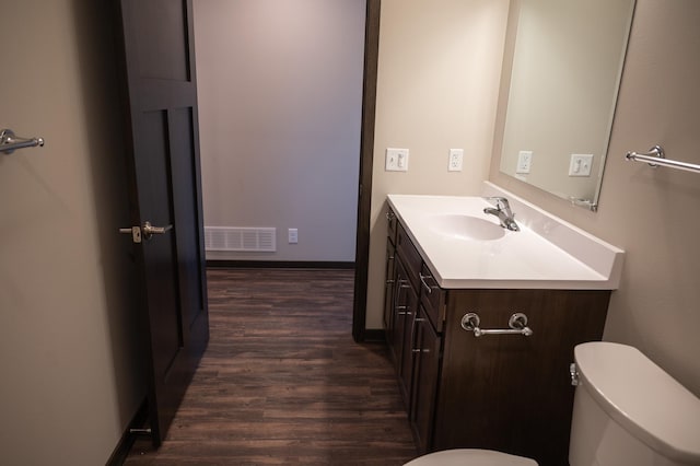 bathroom featuring hardwood / wood-style flooring, vanity, and toilet