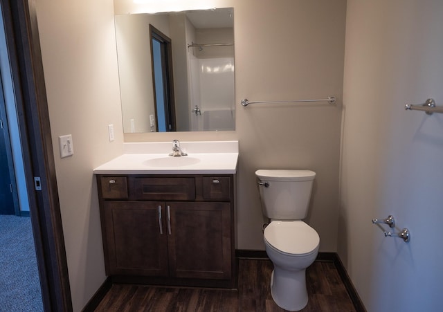 bathroom with hardwood / wood-style flooring, vanity, and toilet