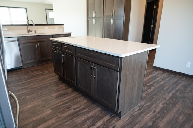 2224 Red Bird Ln, Fairmont, MN 56031 - kitchen featuring dark wood finished floors, stainless steel dishwasher, light countertops, a center island, and dark brown cabinets