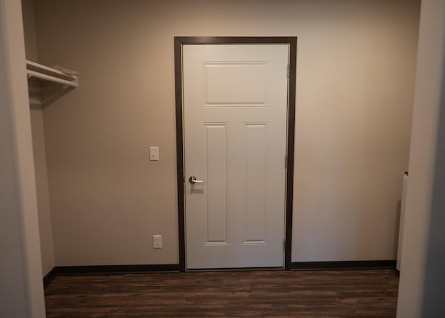 2224 Red Bird Ln, Fairmont, MN 56031 - laundry area with dark wood-type flooring and baseboards