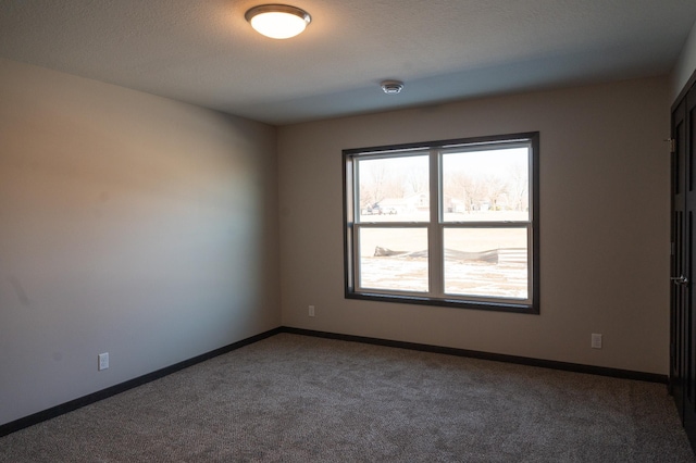 2224 Red Bird Ln, Fairmont, MN 56031 - carpeted spare room featuring baseboards and a smoke detector