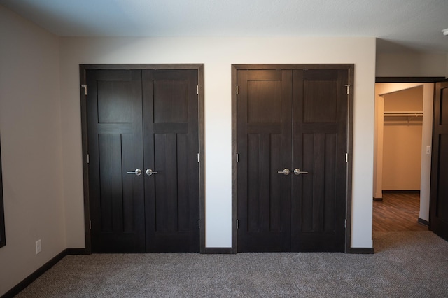 2224 Red Bird Ln, Fairmont, MN 56031 - unfurnished bedroom featuring carpet and two closets