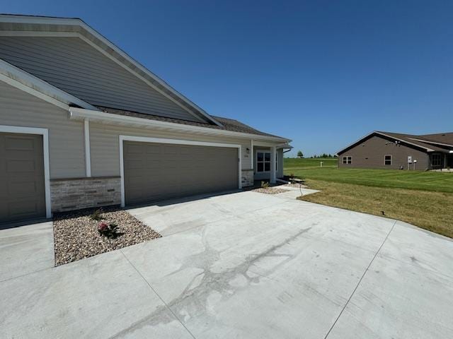 2224 Red Bird Ln, Fairmont, MN 56031 - view of home's exterior featuring a lawn, driveway, and an attached garage