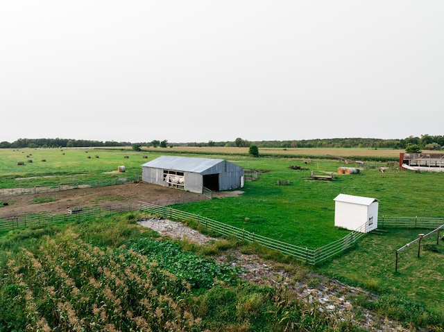 view of yard featuring an outdoor structure and a rural view