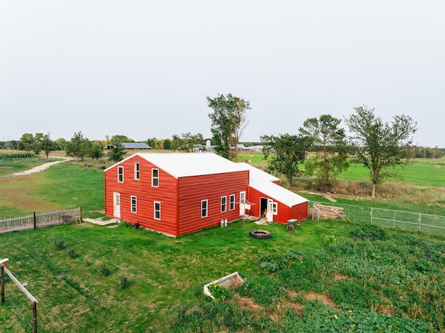 view of outdoor structure with a yard and a rural view