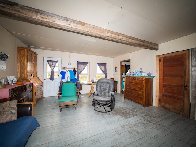 living area with wood-type flooring and beam ceiling