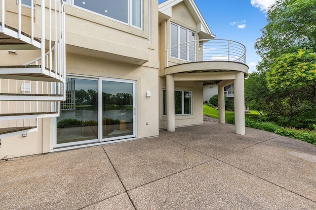 17680 Bearpath Trl, Eden Prairie, MN 55347 - back of house featuring a balcony, stucco siding, and a patio