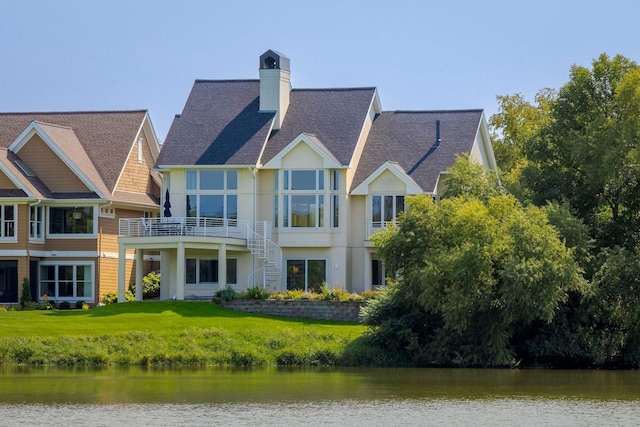 17680 Bearpath Trl, Eden Prairie, MN 55347 - rear view of property featuring a water view, stucco siding, a chimney, and a lawn