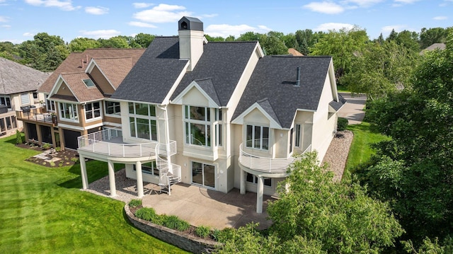 17680 Bearpath Trl, Eden Prairie, MN 55347 - back of property with a shingled roof, a patio, stucco siding, and a chimney