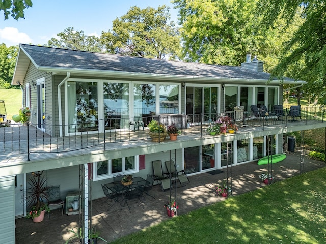 rear view of property with a lawn and a patio area