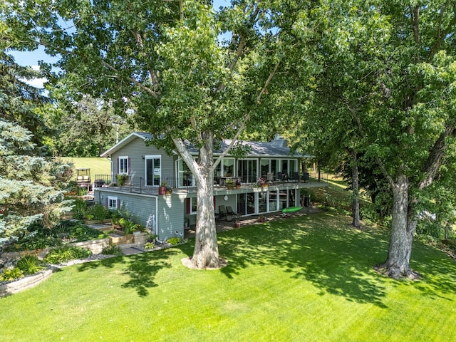 back of house with a lawn