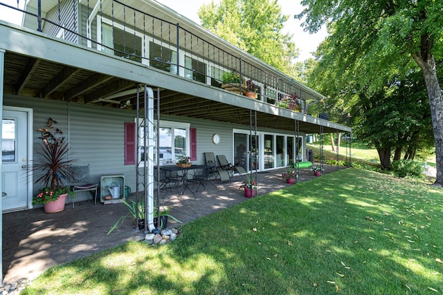 view of yard featuring a balcony and a patio