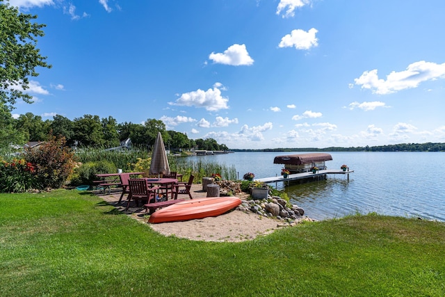 dock area featuring a lawn and a water view