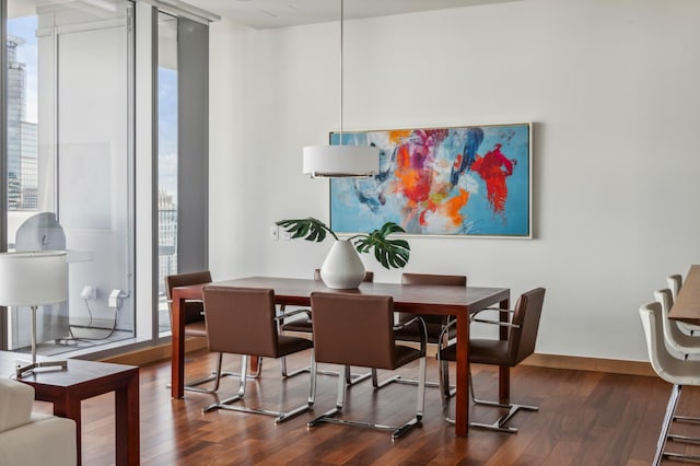 dining space featuring dark hardwood / wood-style floors and expansive windows