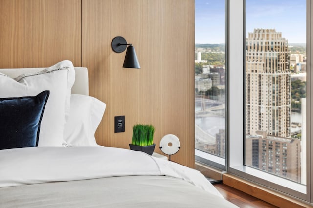 bedroom featuring multiple windows and hardwood / wood-style flooring