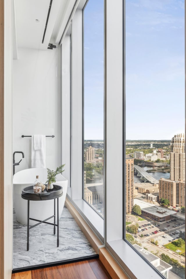 interior space with a water view and hardwood / wood-style flooring