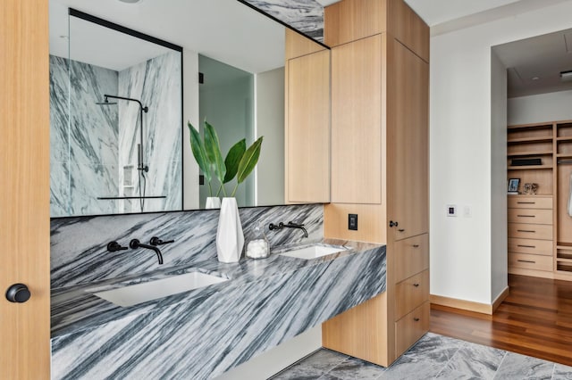 bathroom with vanity, a shower, backsplash, and hardwood / wood-style floors