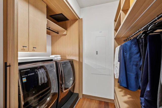 washroom with light hardwood / wood-style flooring and washer and dryer