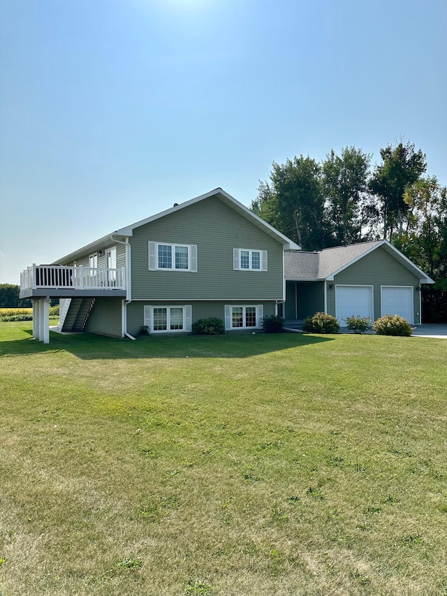 tri-level home featuring a garage, a front lawn, and a wooden deck