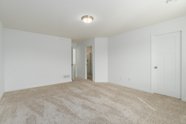 unfurnished room featuring light colored carpet