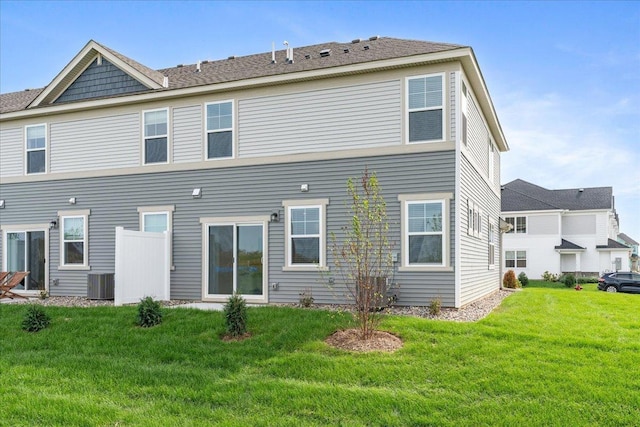 back of house with a yard and cooling unit