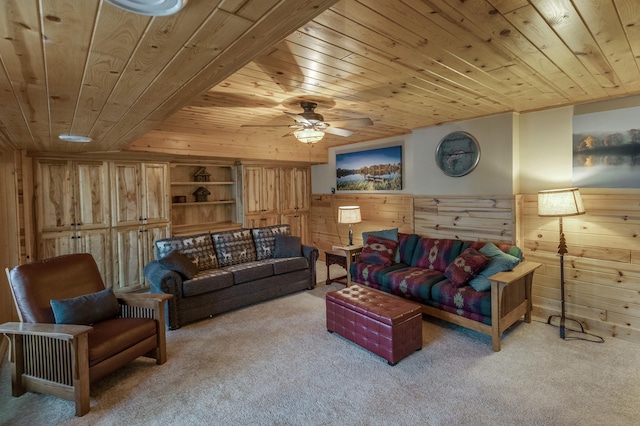 carpeted living room featuring ceiling fan, wooden walls, and wood ceiling