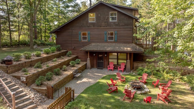 8607 Nottingham Rd, Lake Shore, MN 56468 - back of house featuring a fire pit, a patio, and a lawn