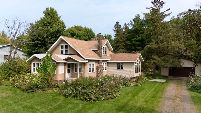 39534 92nd Ave, Onamia, MN 56359 - view of front of home featuring a chimney, an outbuilding, a front lawn, stone siding, and driveway