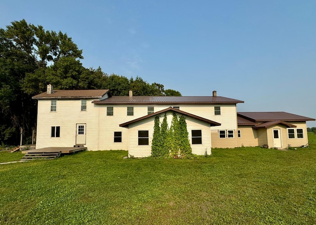 rear view of property featuring a yard